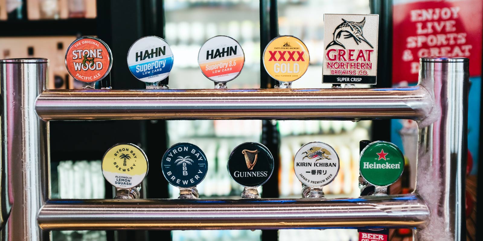 Shot of draft beer logos at the bar.